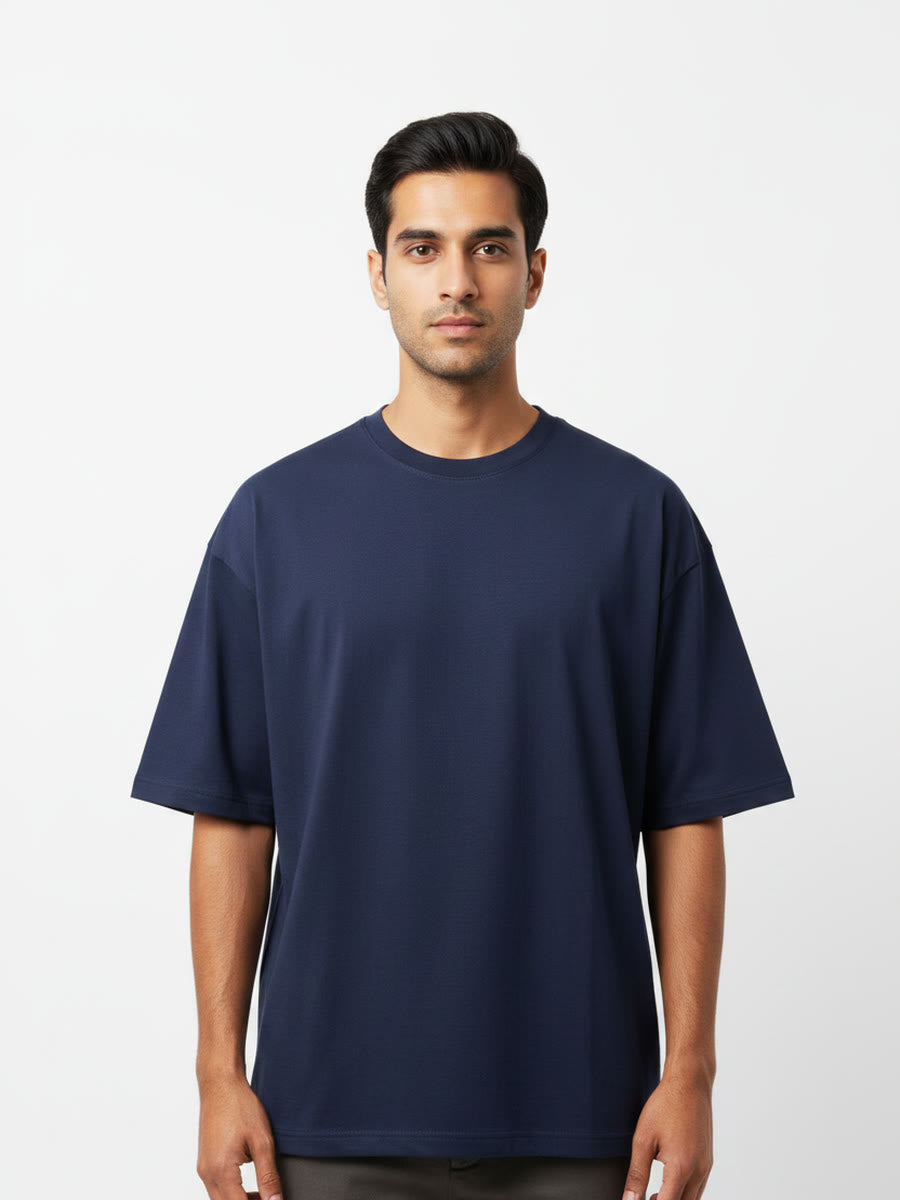 Foldinn drop shoulder tee in Navy, worn by a model