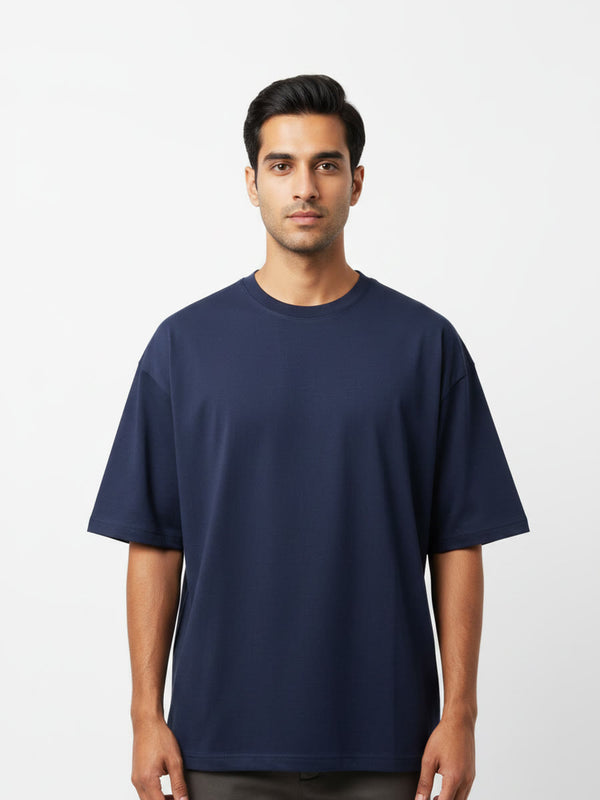 Foldinn drop shoulder tee in Navy, worn by a model