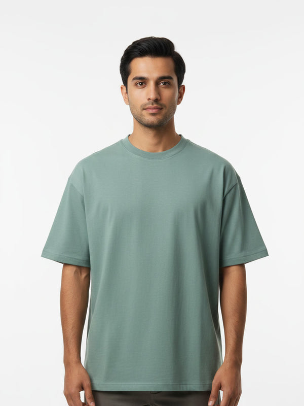 Foldinn drop shoulder tee in Sage Green, worn by a model