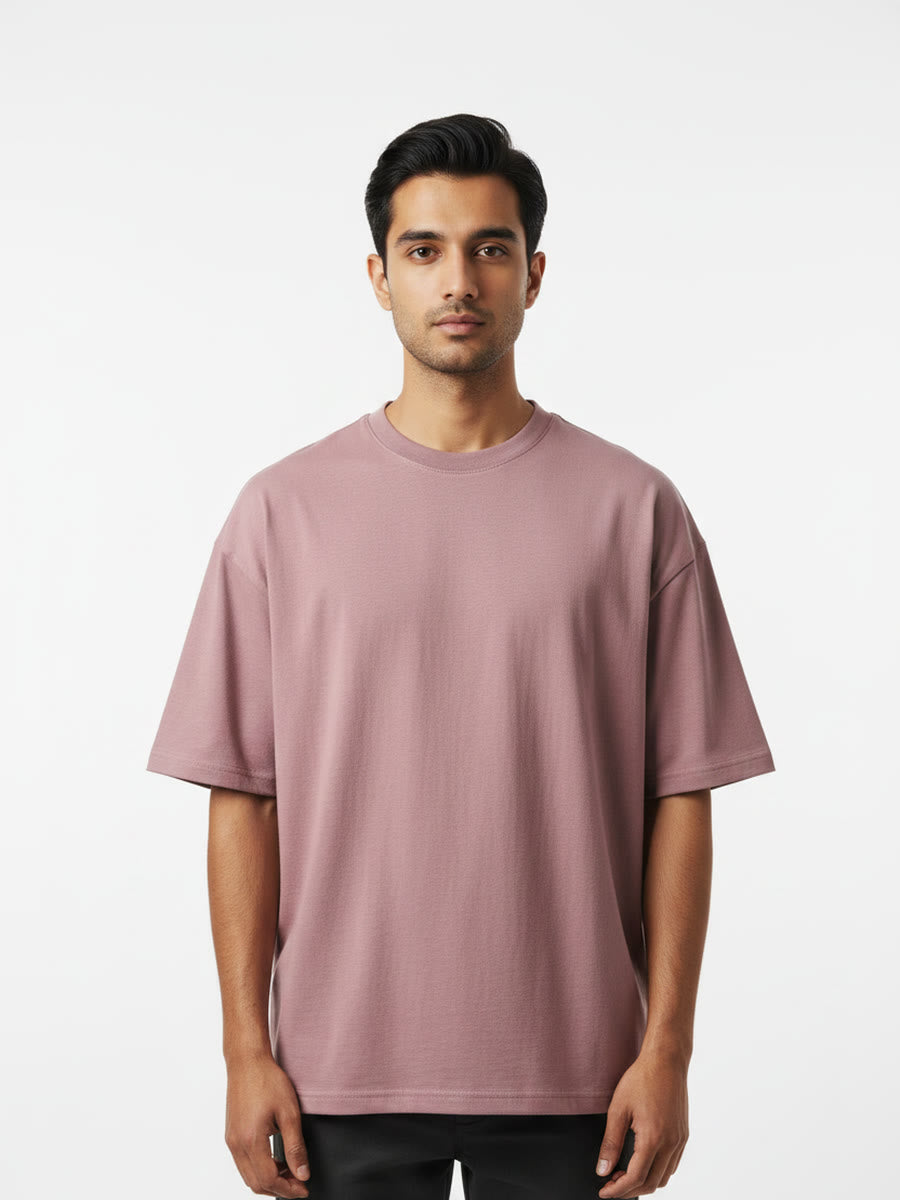 Foldinn drop shoulder tee in Dusty Rose, worn by a model