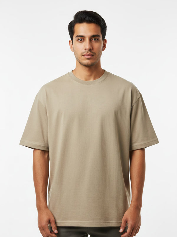 Foldinn drop shoulder tee in Sand, worn by a model